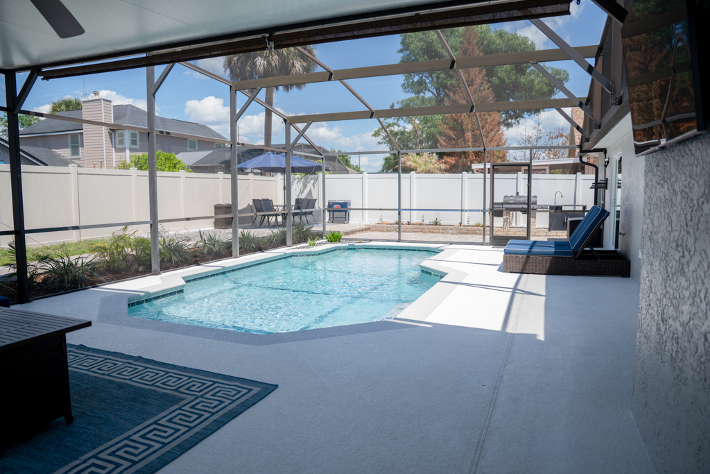 Screened pool viewed from covered lanai seating area