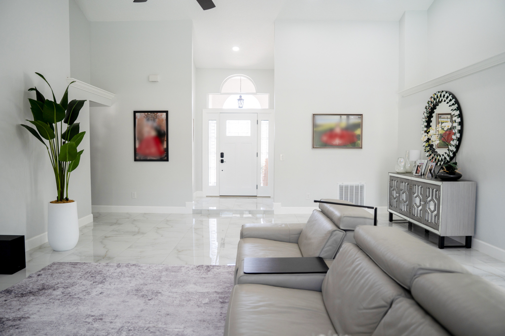 Living room with sectional sofa and view to foyer