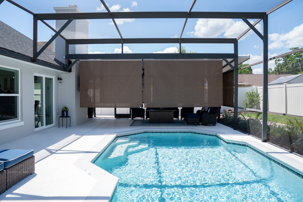 Swimming pool with covered lanai and motorized shade screen