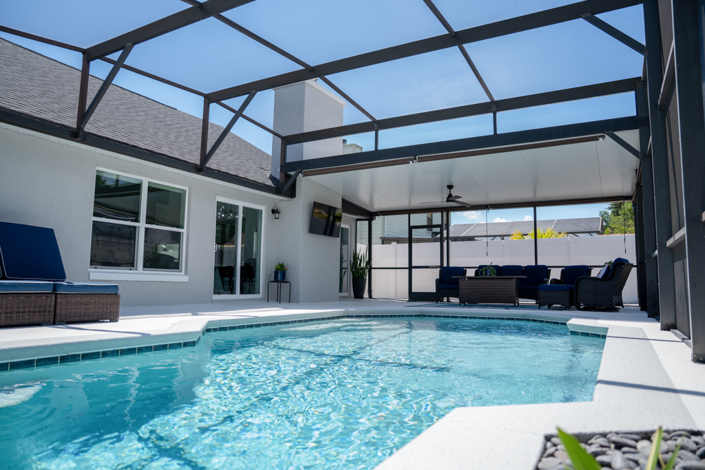 Swimming pool with covered outdoor seating area and exterior of home