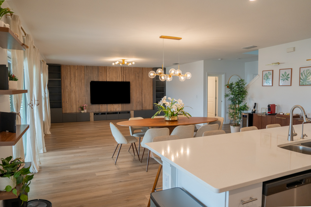 Kitchen counter view looking toward dining room, living room and TV wall