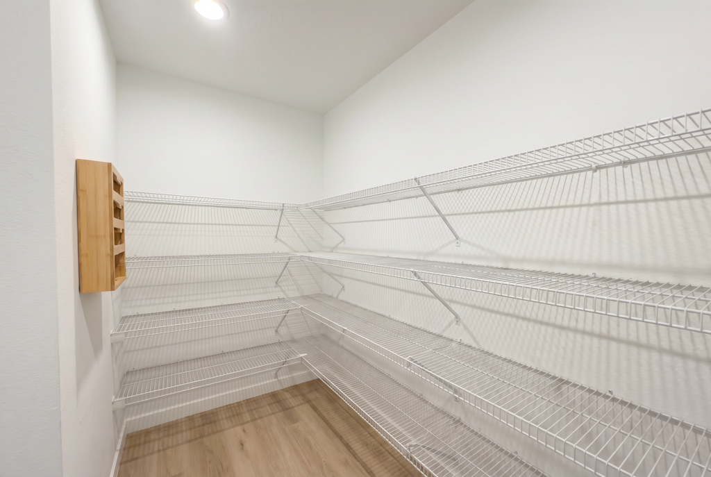 Virtually staged empty walk-in pantry with wire shelving