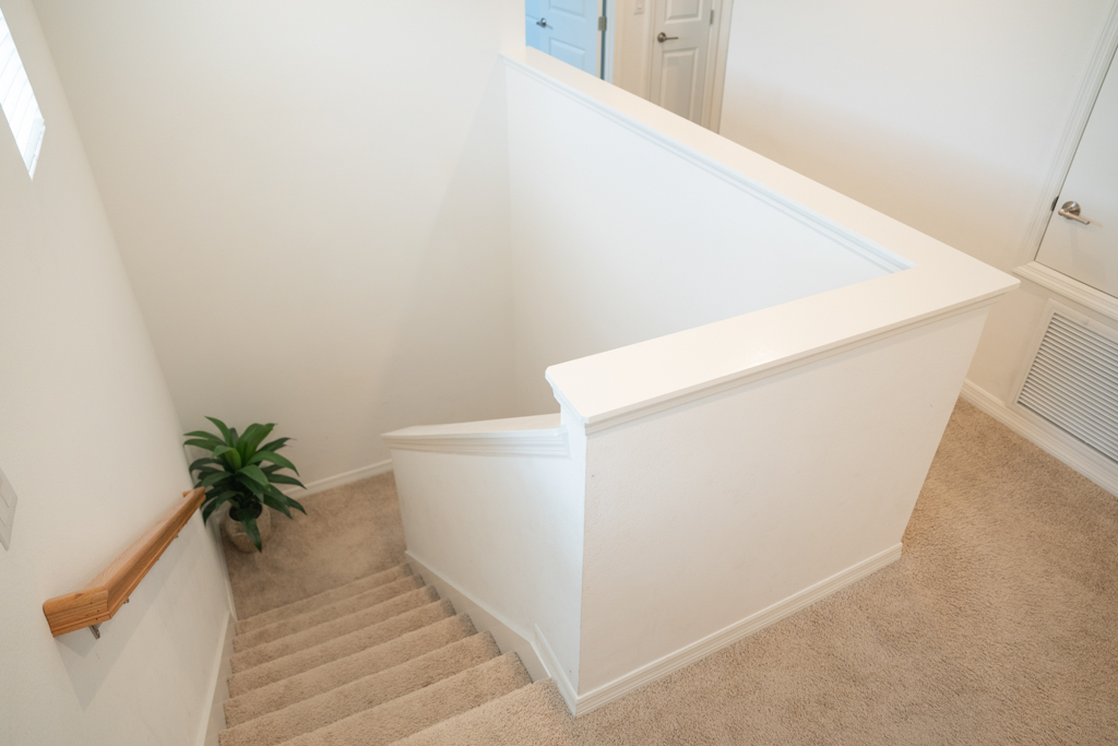 Upstairs staircase landing looking down toward first floor