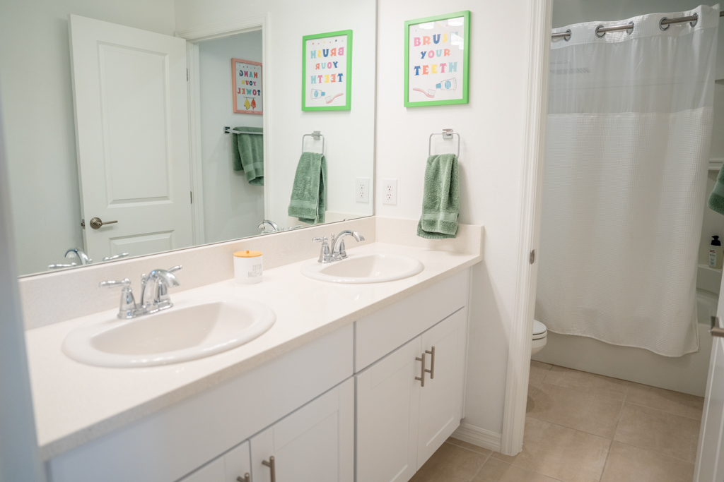 Kids shared bathroom with double vanity and shower-tub combo