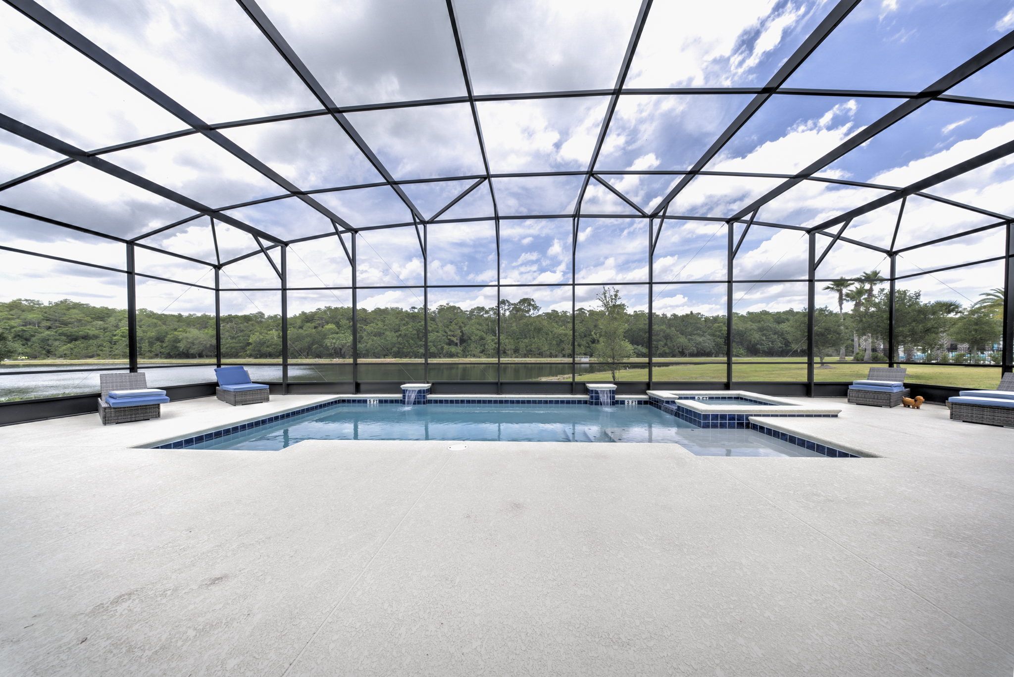 Screened pool with spa, water features and tranquil lake and conservation area view beyond